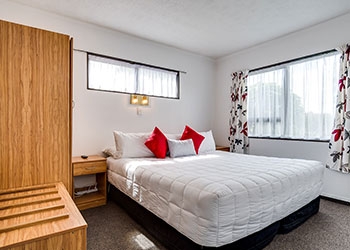 queen-size bed in main room of our 2-bedroom unit